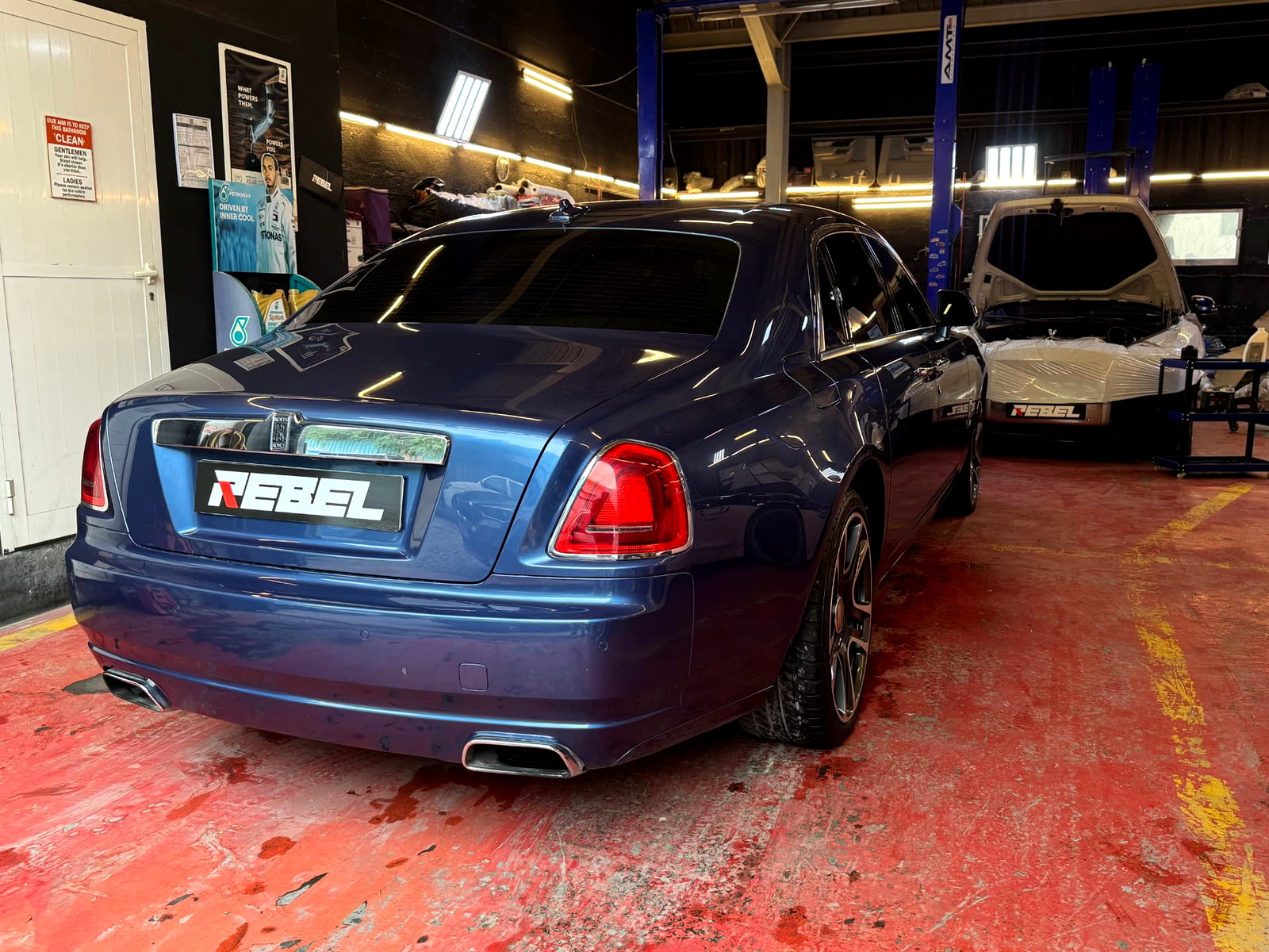 Blue Rolls-Royce Ghost receiving luxury car maintenance at Rebel Motorworks Dubai