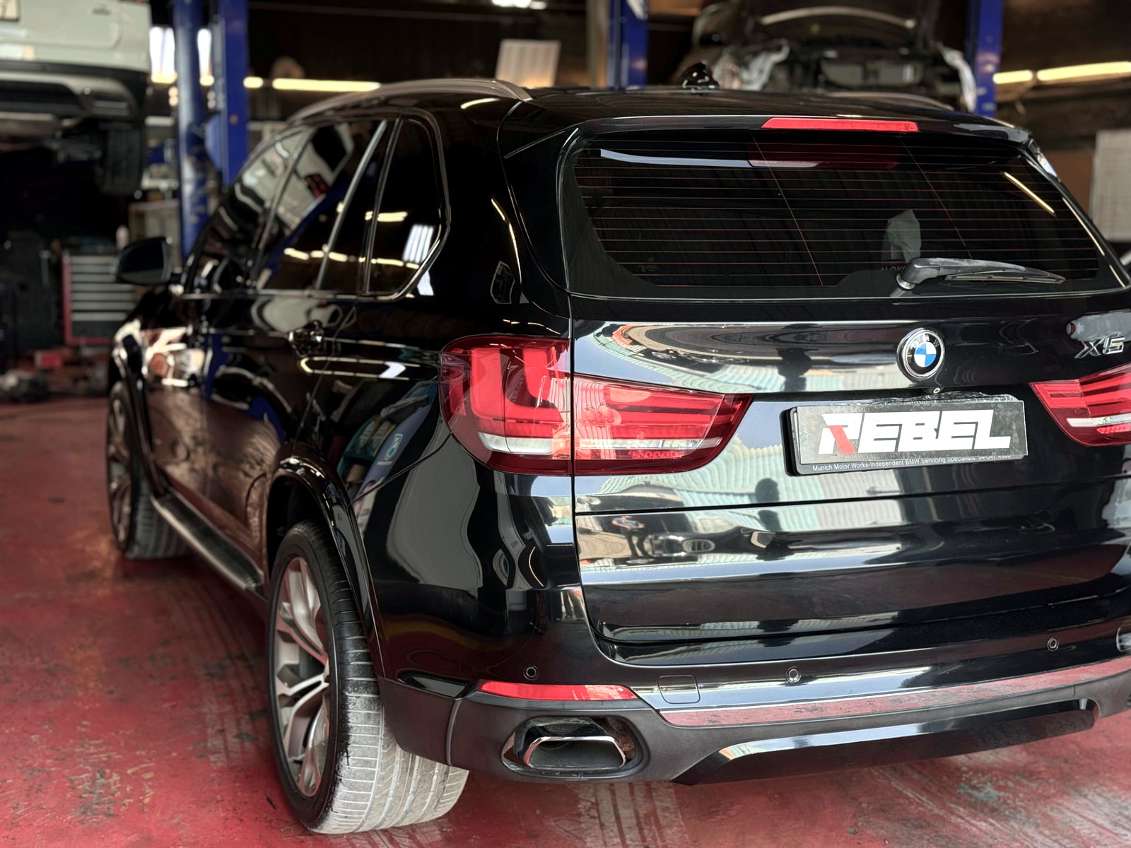 Black BMW X5 after maintenance inside the Rebel Motorworks workshop in Al Quoz