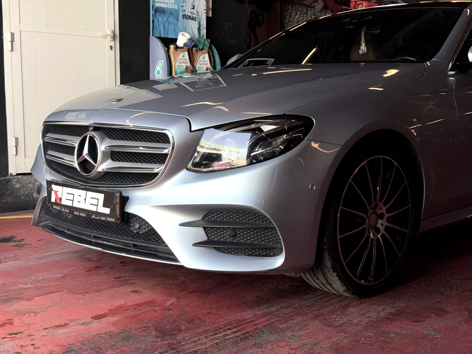 Silver Mercedes-Benz E-Class undergoing specialist servicing at Rebel Motorworks Dubai